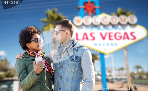 Image of couple with smartphone and earphones at las vegas