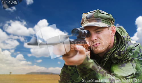 Image of soldier or hunter with gun aiming or shooting