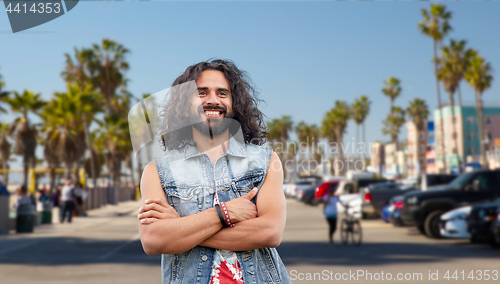 Image of hippie man in demin vest at venice beach in la