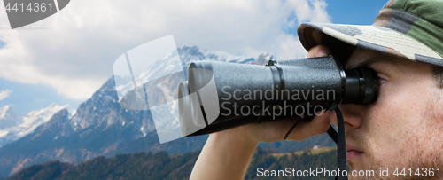 Image of close up of soldier face looking to binocular