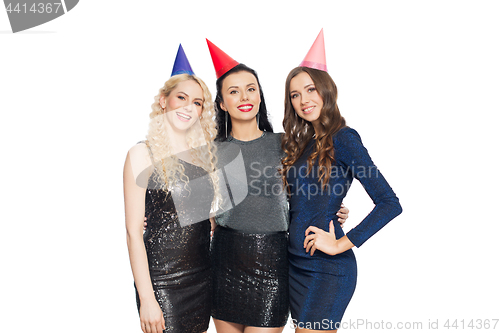 Image of happy women with party caps hugging