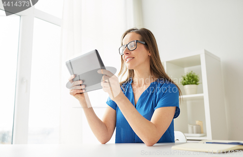 Image of woman with tablet pc working at home or office