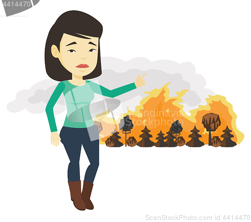 Image of Woman standing on the background of wildfire.