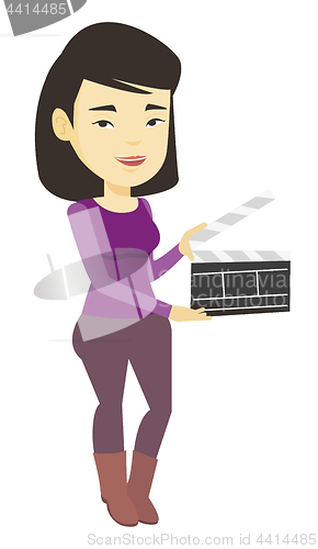 Image of Smiling woman holding an open clapperboard.