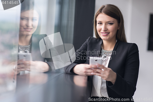 Image of Business Girl Standing In A Modern Building Near The Window With