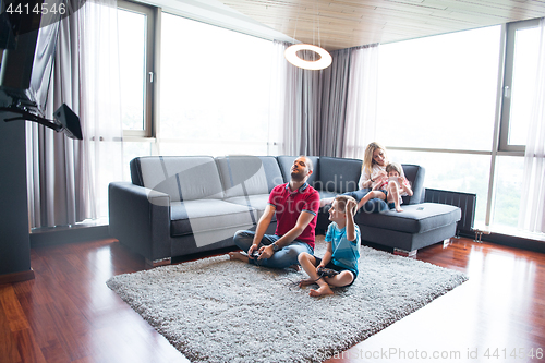 Image of Happy family playing a video game