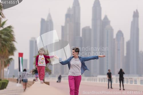 Image of mother and cute little girl on the promenade