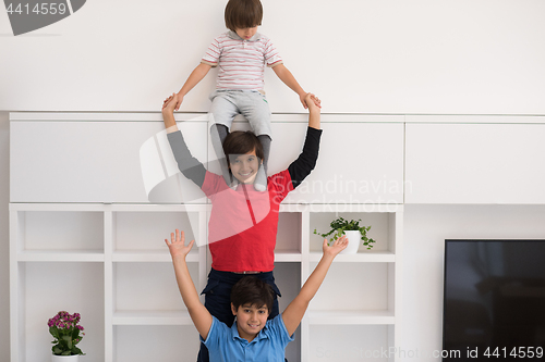 Image of young boys posing line up piggyback