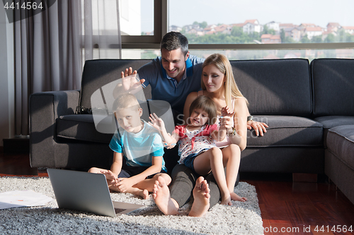 Image of Family Playing Together with laptop computer