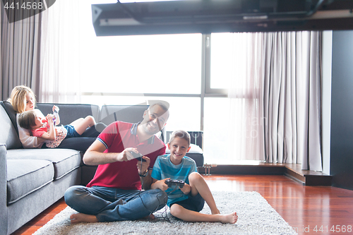 Image of Happy family playing a video game