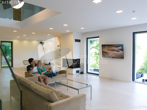 Image of young happy couple relaxes in the living room