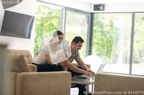 Image of happy young couple buying online