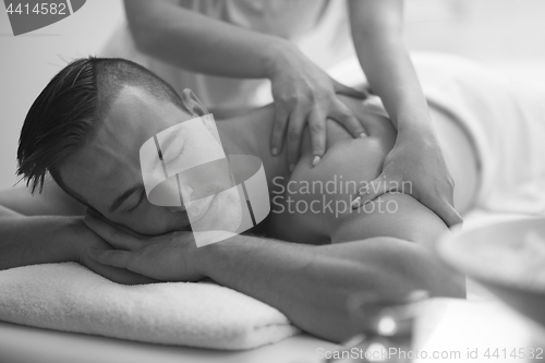 Image of young man having a back massage