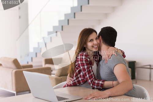 Image of happy young couple buying online