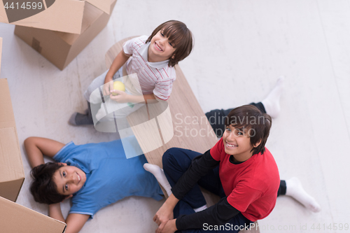 Image of boys with cardboard boxes around them top view