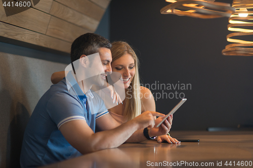 Image of couple using tablet at home