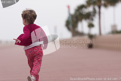 Image of cute little girl on the promenade by the sea