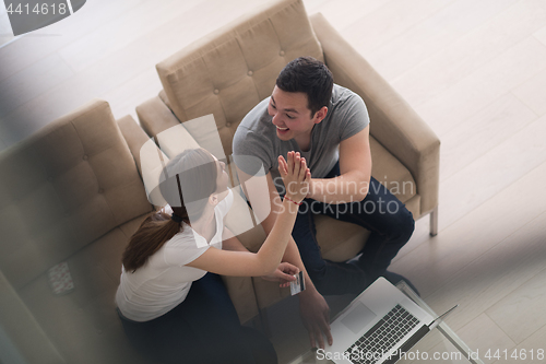 Image of happy young couple buying online