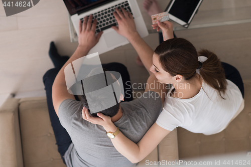 Image of happy young couple buying online