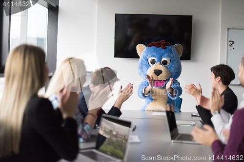 Image of boss dresed as bear having fun with business people in trendy of