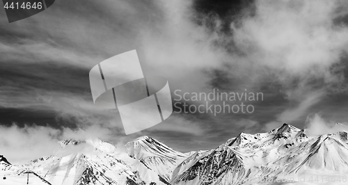 Image of Black and white winter snowy mountains in fog