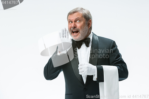 Image of Senior waiter holding white towel