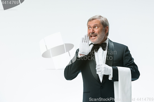 Image of Senior waiter holding white towel