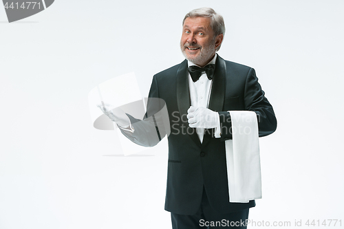 Image of Senior waiter holding white towel