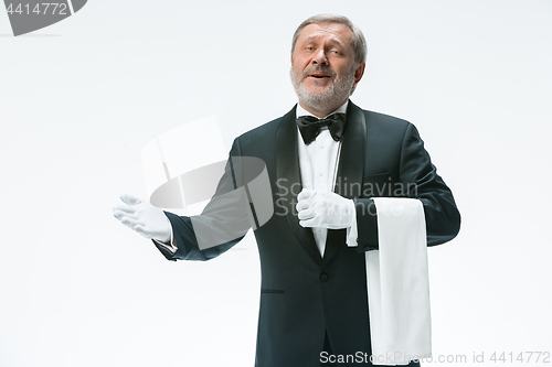 Image of Senior waiter holding white towel