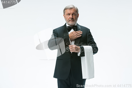 Image of Senior waiter with white towel. Sign language in the restaurant