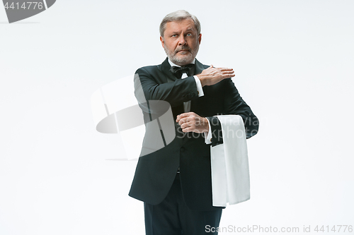 Image of Senior waiter with white towel. Sign language in the restaurant