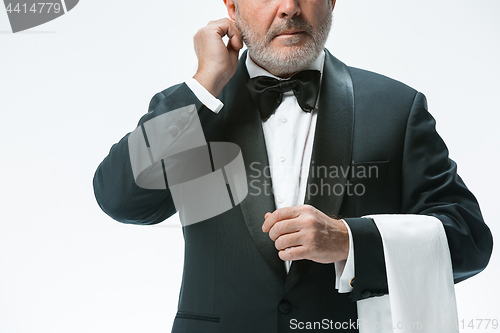 Image of Senior waiter with white towel. Sign language in the restaurant