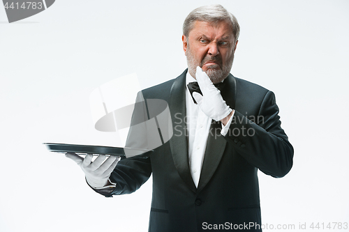 Image of Senior waiter holding tray