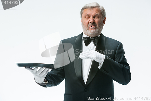 Image of Senior waiter holding tray