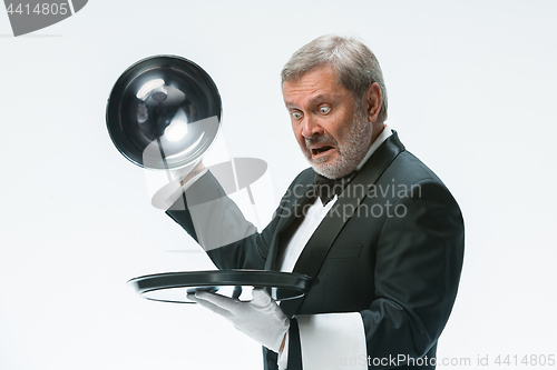 Image of The waiter with tray and metal cloche lid cover