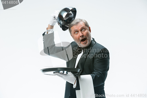 Image of The waiter with tray and metal cloche lid cover