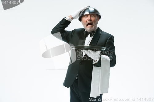 Image of The waiter with tray and metal cloche lid cover