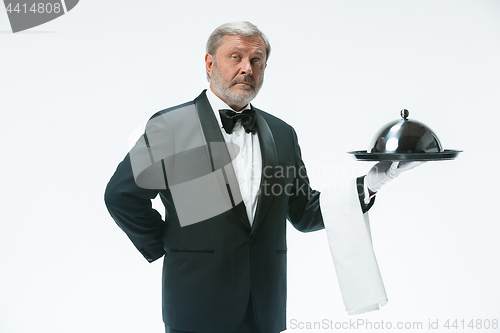 Image of The waiter with tray and metal cloche lid cover
