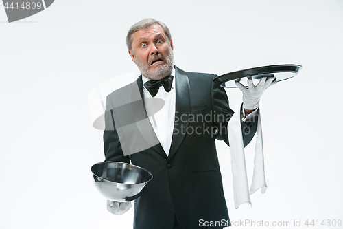 Image of The waiter with tray and metal cloche lid cover