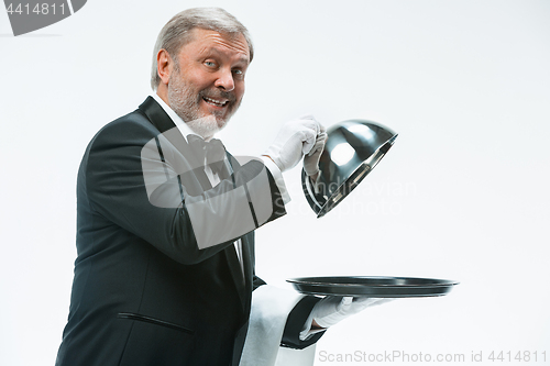 Image of The waiter with tray and metal cloche lid cover