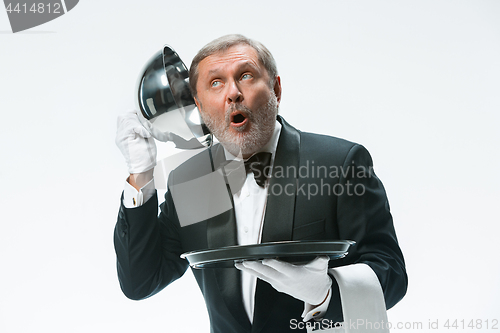 Image of The waiter with tray and metal cloche lid cover