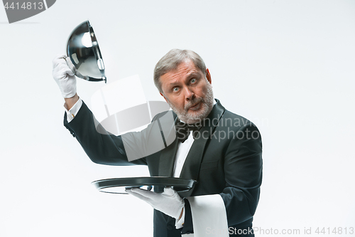 Image of The waiter with tray and metal cloche lid cover