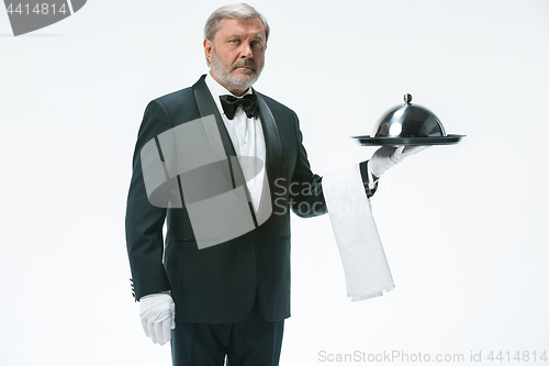 Image of The waiter with tray and metal cloche lid cover