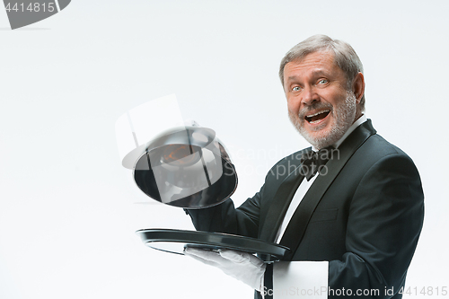 Image of The waiter with tray and metal cloche lid cover