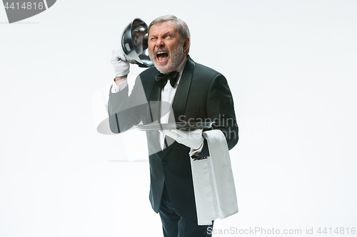 Image of The waiter with tray and metal cloche lid cover