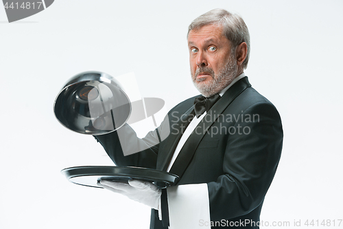 Image of The waiter with tray and metal cloche lid cover