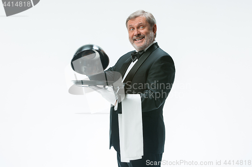 Image of The waiter with tray and metal cloche lid cover