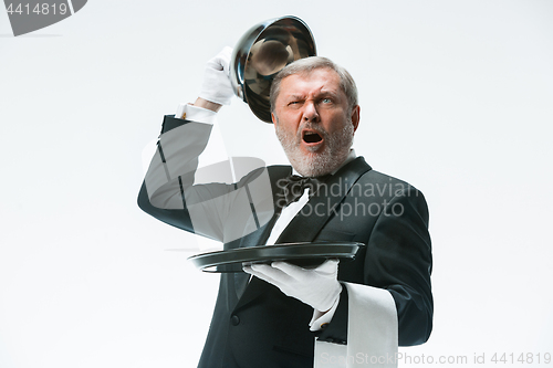 Image of The waiter with tray and metal cloche lid cover