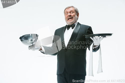 Image of The waiter with tray and metal cloche lid cover