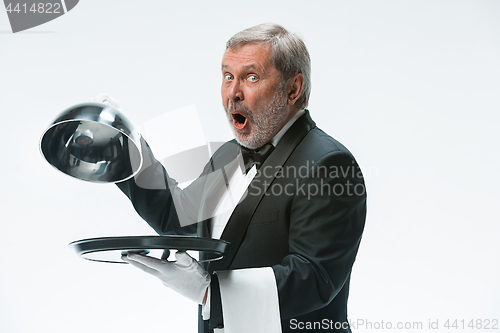 Image of The waiter with tray and metal cloche lid cover